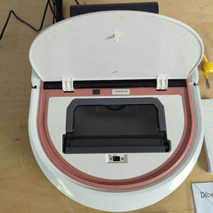 Actual unit: Dibea D500 Pro with top lid open showing the dust bin