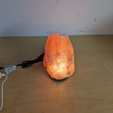 Actual unit: Himalayan salt lamp lit on its wooden base