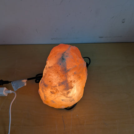 Actual unit: Himalayan salt lamp lit on its wooden base
