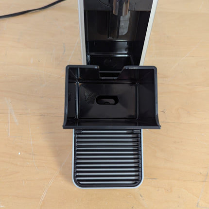Actual unit: Nespresso Pixie by Breville with drip tray and used capsule container pulled out