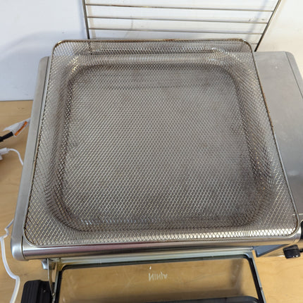 Actual unit: Ninja Foodi SP101C air fry basket with cooking stains